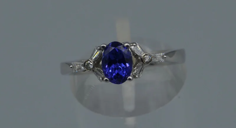 Ladies effortless daily rings -14K white gold ring with one center oval Tanzanite and six side Diamond baguettes